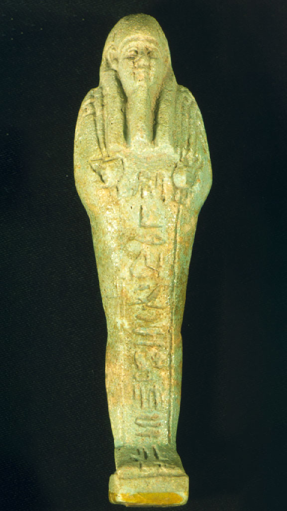 greenish stone carving of a mummy with hieroglyphics